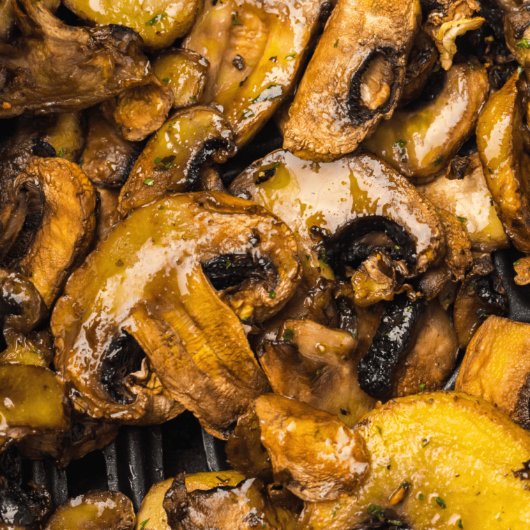 Sautéed mushrooms with steak and ale, served as a flavorful side dish.