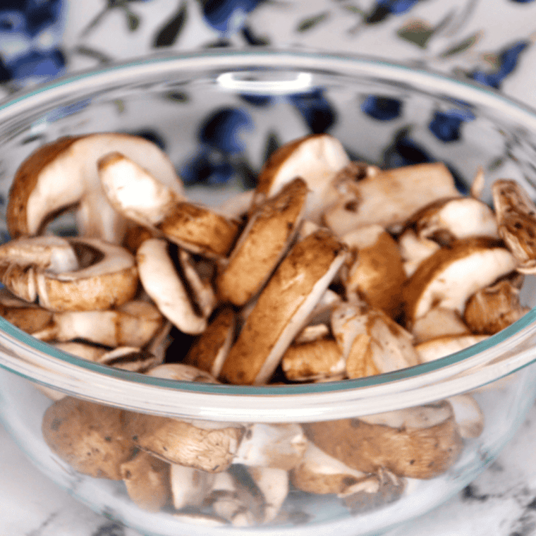 Ingredients needed for Steak and Ale Sauteed Mushrooms on kitchen table.