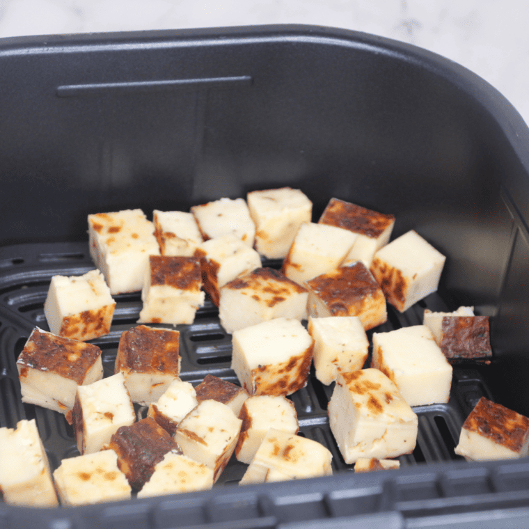 Place the bread cubes into the air fryer basket.