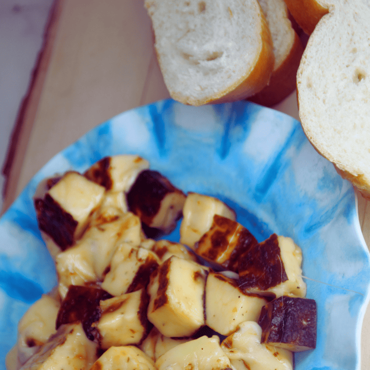Close up of Bread Cheese on kitchen table on a blue plate.