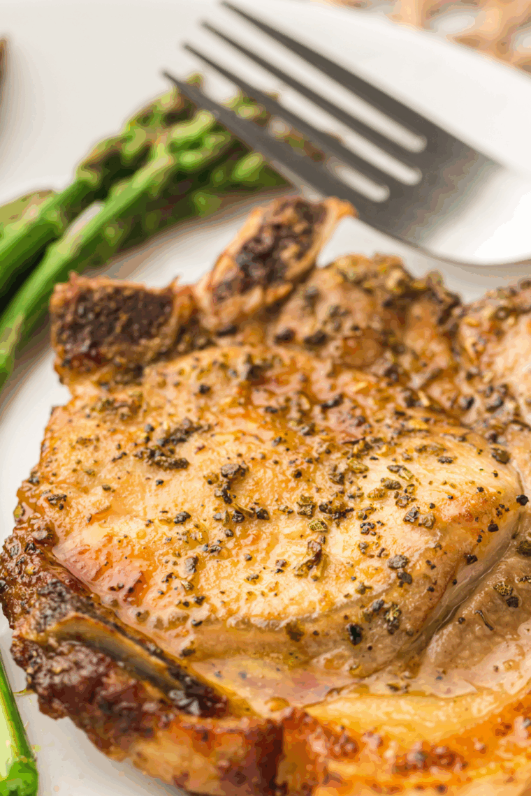 Golden brown Waffle House-style pork chops served hot on a plate with garnish