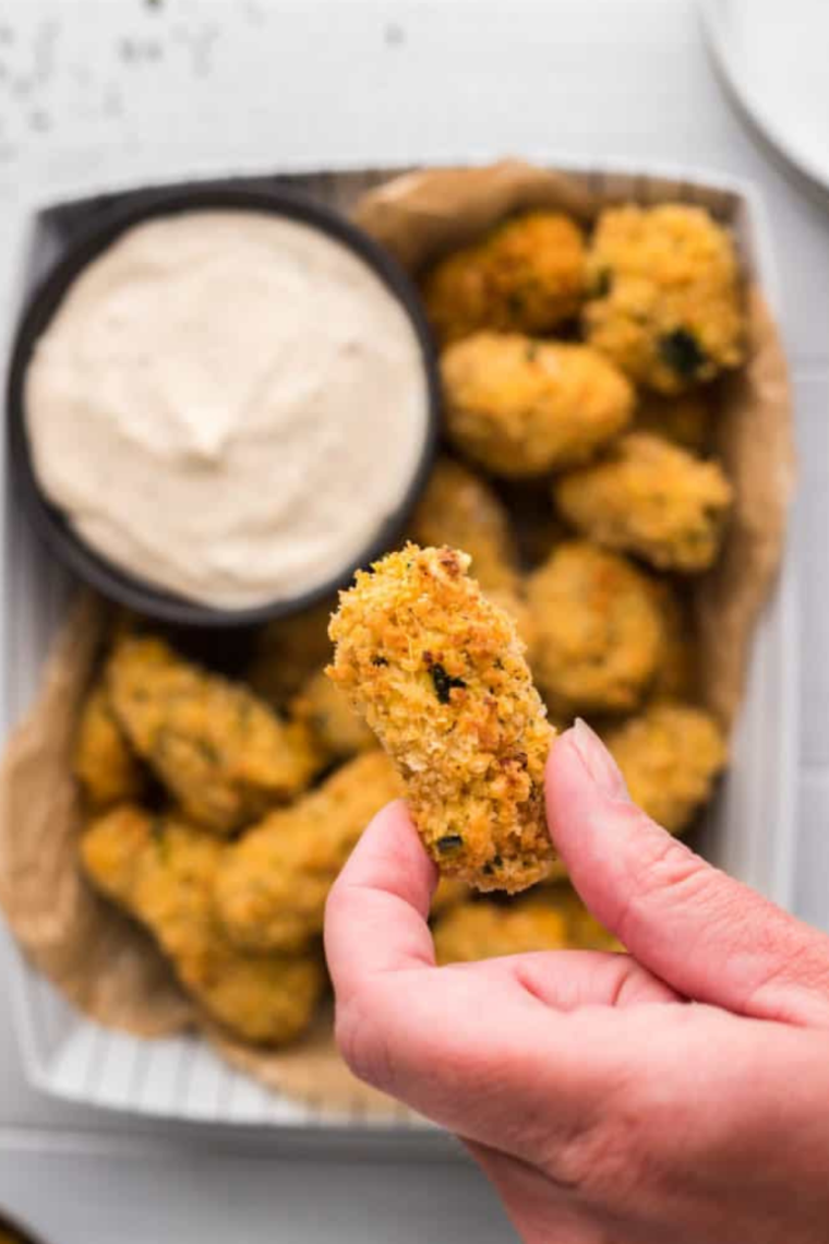 Crispy air fryer cheese curds on a white plate with ranch dressing