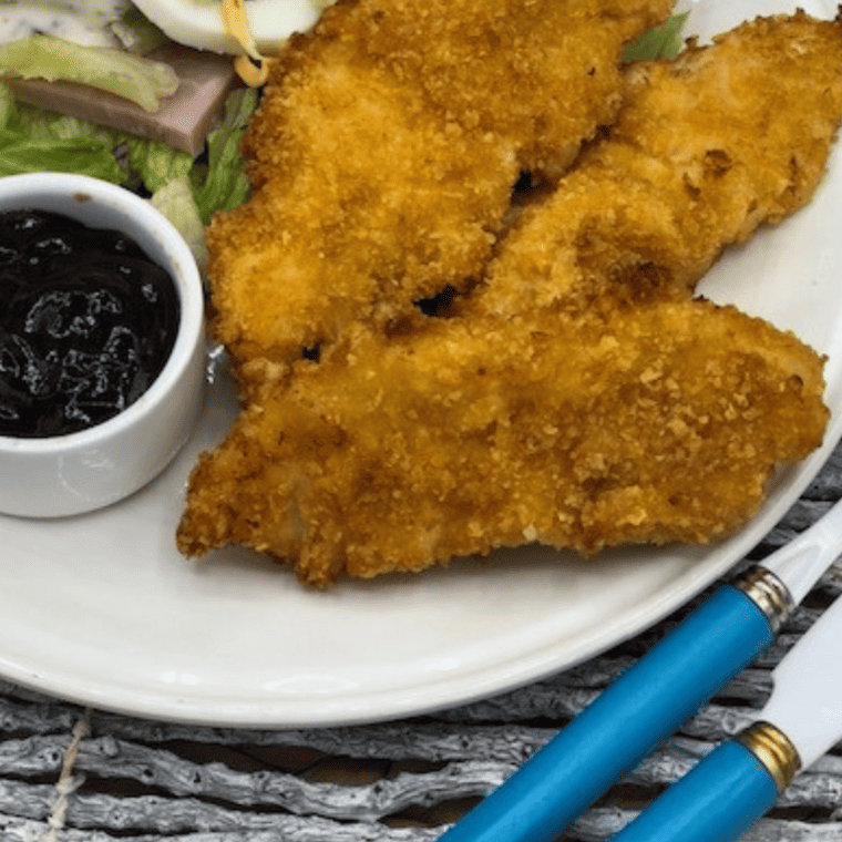 A close-up texture shot of the crispy, seasoned breading on a homemade Bojangles chicken tender.
