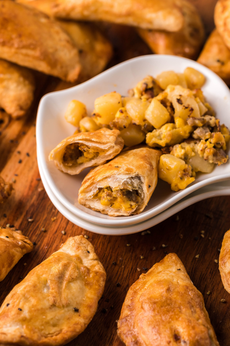 Air fryer empanadas on a plate with dipping sauce