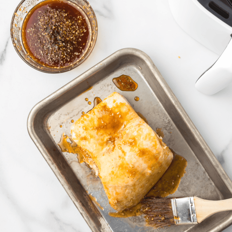 Cooking Pork Belly in Air Fryer - Pork belly pieces arranged in an air fryer basket, ready to be cooked for a crispy texture.