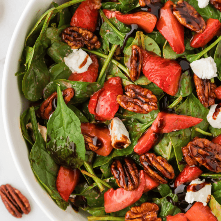 Air Fryer Spinach Strawberry Salad with fresh spinach, ripe strawberries, and a crispy air-fried topping, served in a bowl.