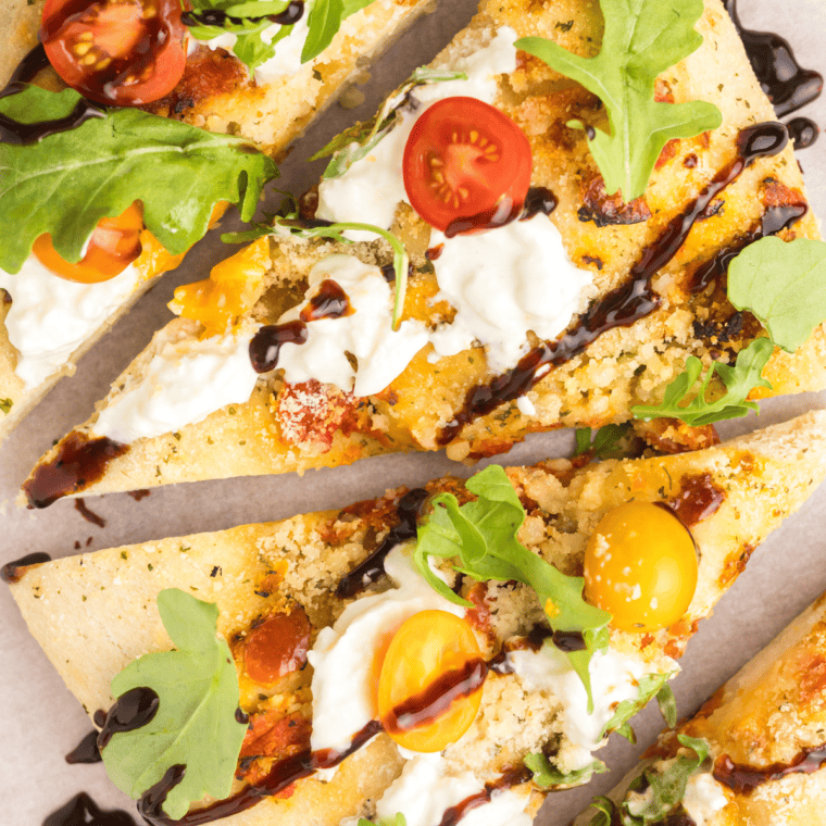 Trader Joe's burrata focaccia topped with creamy burrata cheese, drizzled with olive oil, and garnished with fresh herbs.