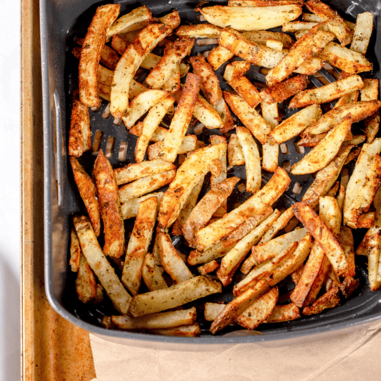 Air frying the fries until golden brown and crispy, with a timer displayed.