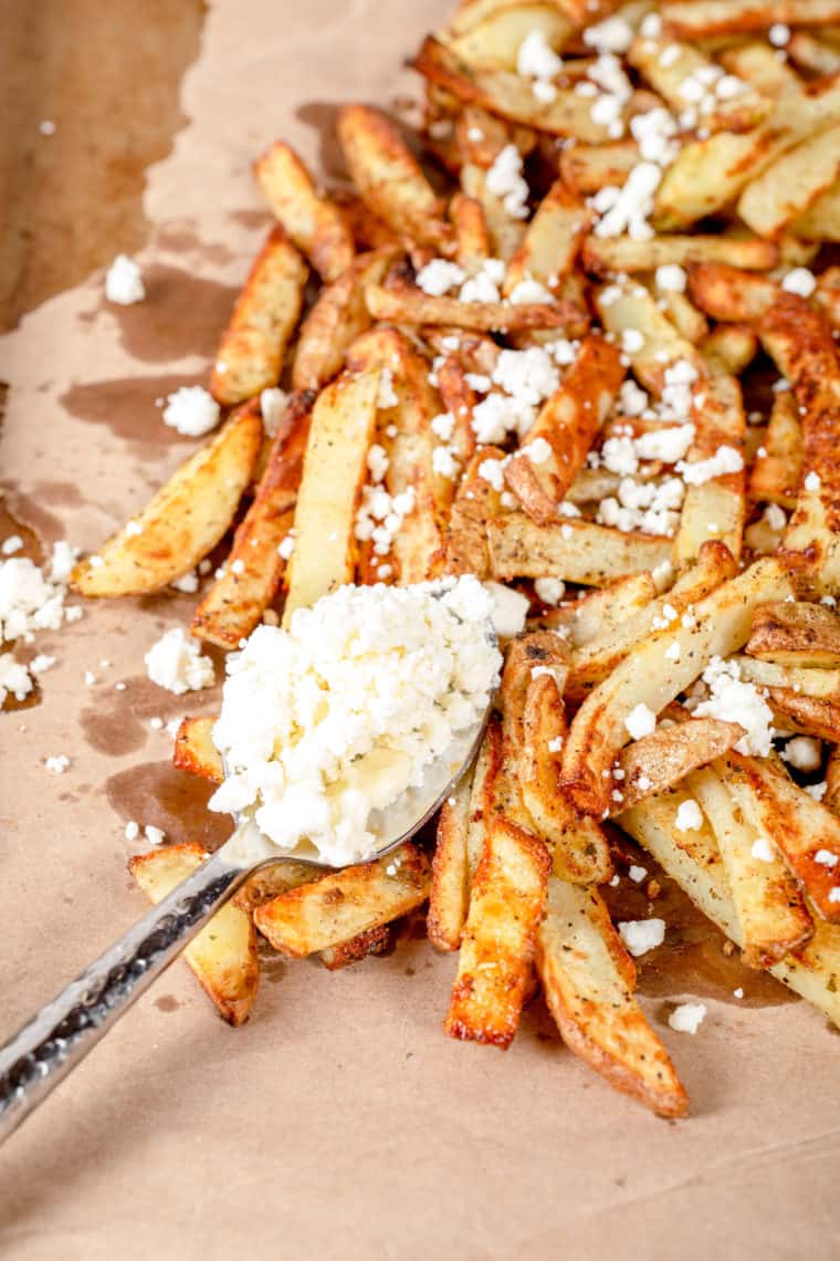 Air Fryer Truffle Fries served in a rustic bowl with fresh herbs sprinkled on top.