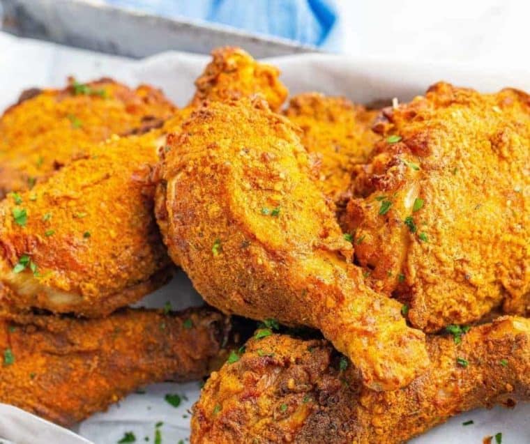 Close up of drumsticks, thighs, and breasts made with this KFC chicken recipe.