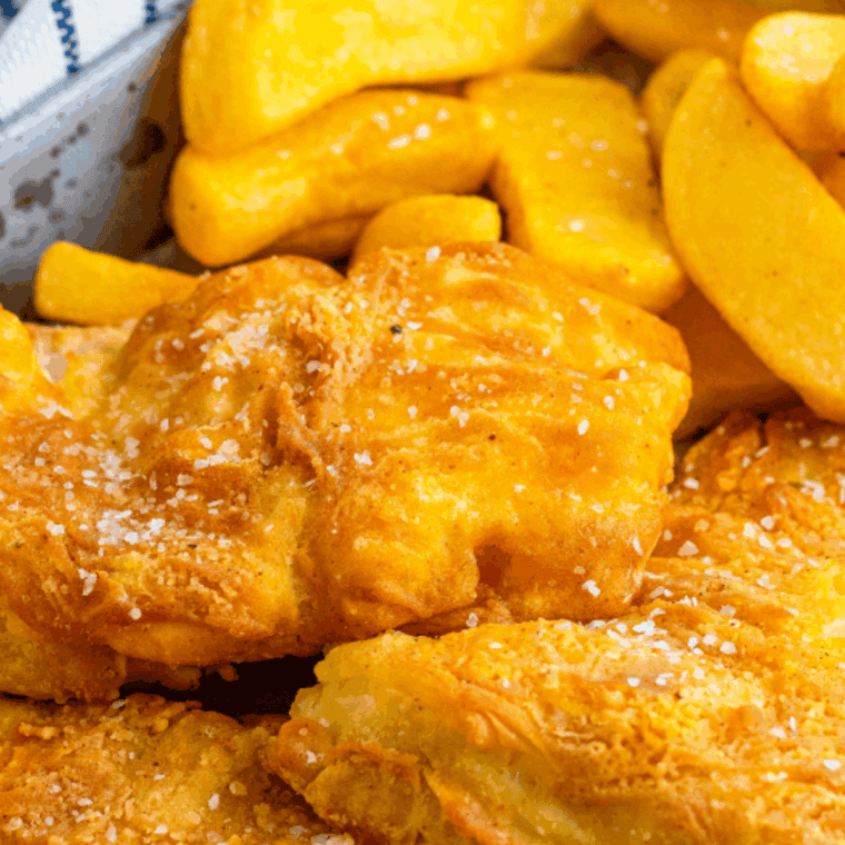 Crispy reheated fish and chips in an air fryer basket