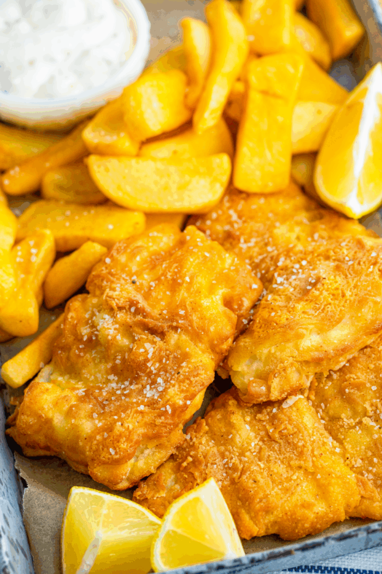 Golden crispy fish and chips reheated in an air fryer basket