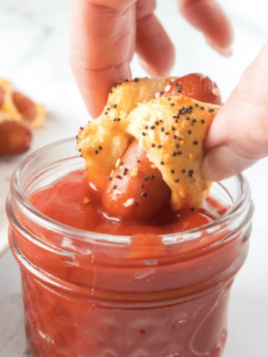Air fryer bagel dogs on a white plate served with mustard and ketchup