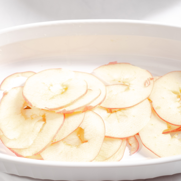 Thinly slicing apples into rounds with a mandoline for apple chips