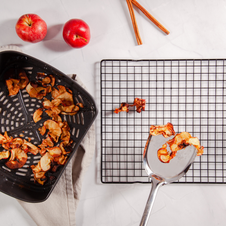 Apple slices arranged in a single layer in the air fryer basket