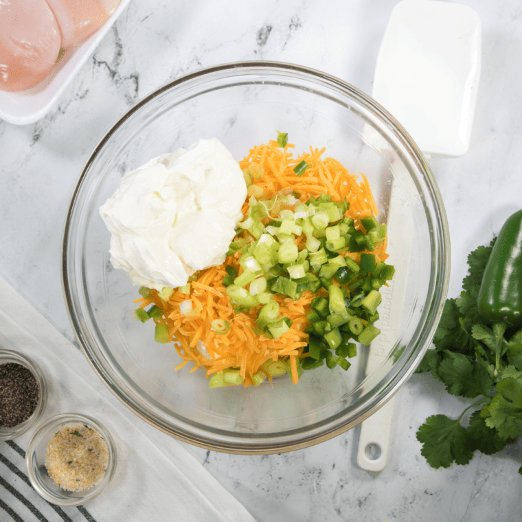 Softening cream cheese in a large bowl by microwaving for easier mixing with casserole ingredients