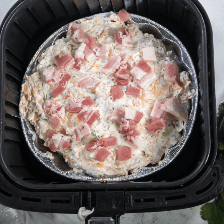  Cooking chicken breasts in an oven-safe dish inside the air fryer at 350°F, adjusting cook time based on size and air fryer model