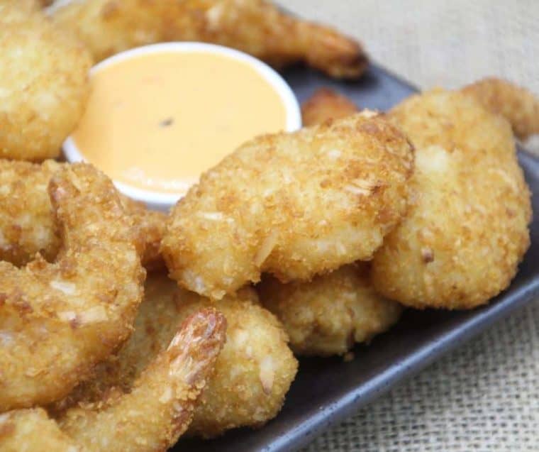 1. What Is Trader Joe's Coconut Shrimp?
Trader Joe's Coconut Shrimp is a frozen food product. It consists of shrimp coated in a crispy breading that includes shredded coconut, giving it a sweet and savory flavor profile.
2. How Do You Cook Trader Joe's Coconut Shrimp?
The shrimp can be cooked in several ways: air-fried, baked in a conventional oven, or even deep-fried. The most popular and healthiest method is air frying, as it requires less oil and still achieves a crispy texture.
3. Is Preheating Necessary When Air Frying the Shrimp?
Yes, preheating the air fryer is recommended for optimal results. It helps the shrimp cook evenly and become crispy.
4. Can You Cook the Shrimp from Frozen?
Yes, Trader Joe's Coconut Shrimp is designed to be cooked straight from frozen, which adds to its convenience.
5. What Are Good Dipping Sauces for Coconut Shrimp?
Popular choices include sweet chili sauce, mango salsa, or a tangy tartar sauce. The sweetness of these sauces complements the coconut flavor well.
6. How Long Does It Take to Cook the Shrimp in an Air Fryer?
It typically takes about 6-8 minutes at 400°F (200°C) in an air fryer, but this can vary depending on the air fryer model.
7. Are Trader Joe's Coconut Shrimp Gluten-Free?
No, they are not gluten-free as the breading contains wheat. Those with gluten sensitivities or celiac disease should avoid this product.
8. Can the Shrimp Be Microwaved?
While microwaving is possible, it is not recommended as it won’t provide the crispy texture that baking or air frying will achieve.
9. How Many Servings Are in a Package?
This can depend on the package size and individual serving preferences. Check the package for specific serving size information.
10. Are There Any Allergens in Trader Joe's Coconut Shrimp?
Yes, the shrimp contain shellfish, wheat, and coconut, which are common allergens. Always check the label for allergen information.