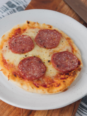 This air fryer pepperoni naan pizza cooks in 8 minutes flat using a 380°F pre-crisp trick that keeps the bottom shatter-crisp instead of soggy. With six pantry ingredients and one piece of naan bread, you get a personal pizza that beats delivery — every single time.