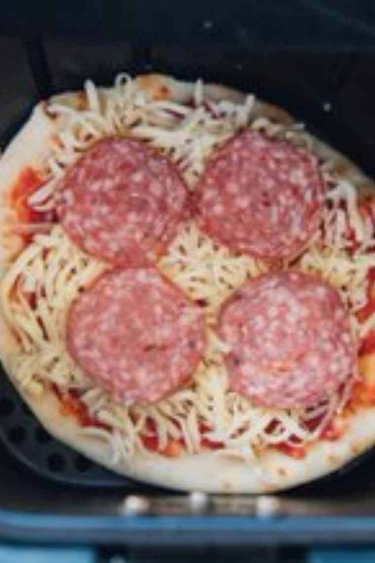 Cook for 4 minutes
Loaded pepperoni naan pizza cooking in the air fryer at 380°F with melted bubbling mozzarella, golden-brown crispy edges, and pepperoni curling at the edges