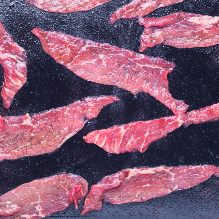 Blackstone griddle heating to 350–375°F with a light coat of oil, ready for stir-frying beef and broccoli.