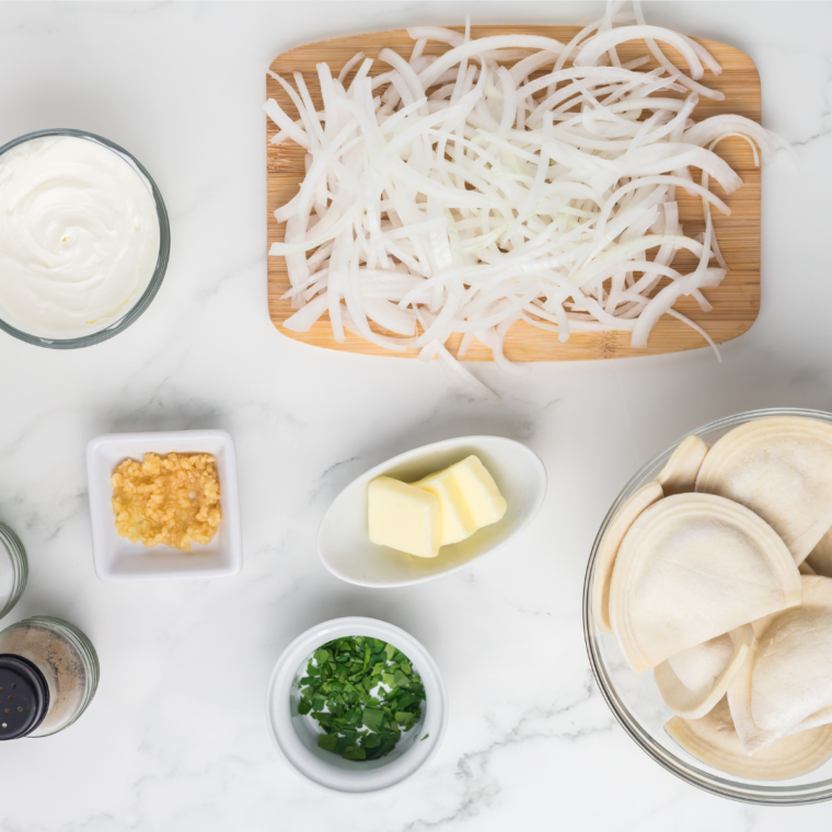 Ingredients for Blackstone pierogies and onions laid out on a kitchen table