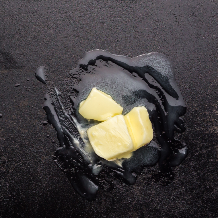 Blackstone griddle heating over medium heat with butter, ready to cook pierogies