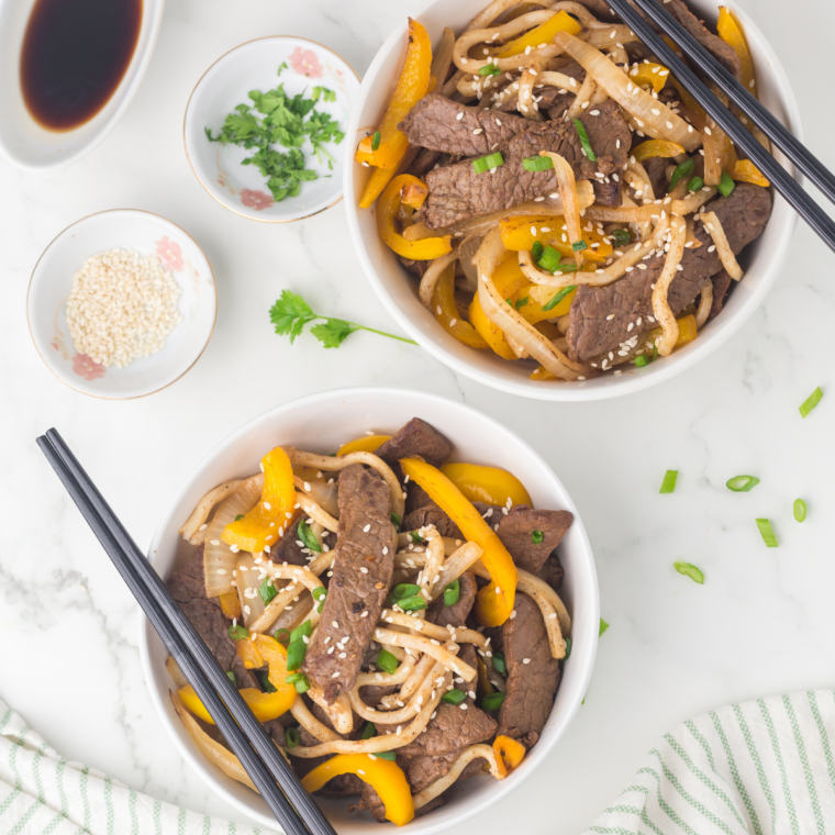 Blackstone Steak Udon with seared steak, udon noodles, and vegetables on a griddle