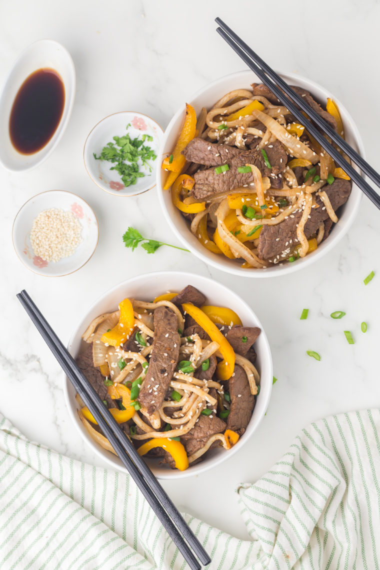 Finished steak udon tossed with green onions and sesame seeds