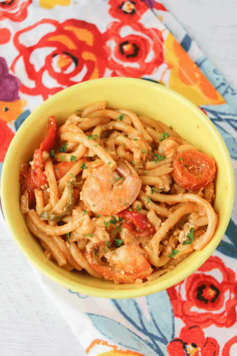 Cajun Jambalaya Pasta with chicken, shrimp, sausage, and creamy Cajun sauce, served on a white plate garnished with parsley.