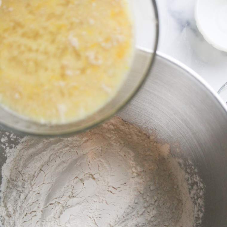 Rolling risen povitica dough into a rectangle and spreading walnut filling