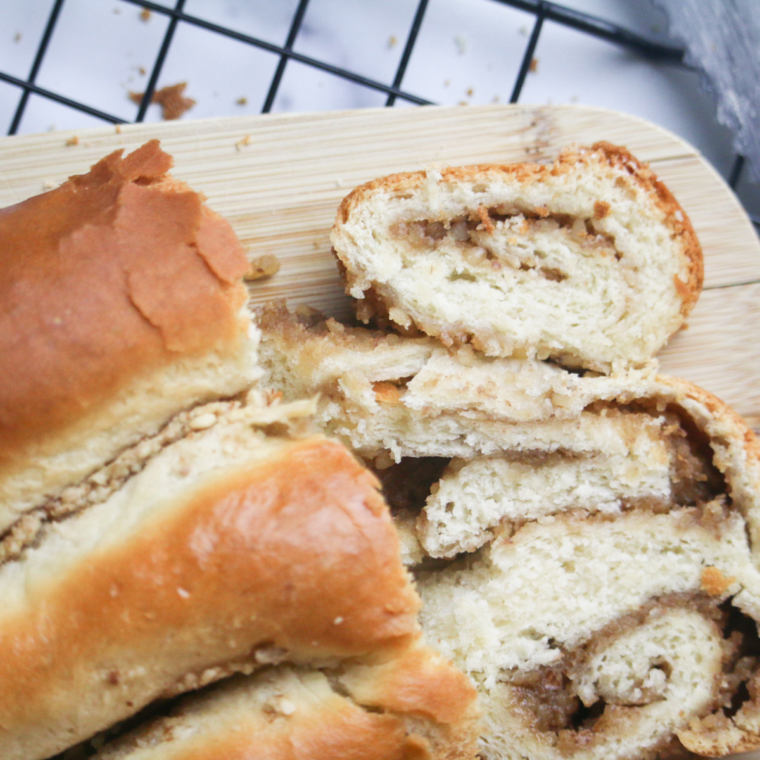 Air fryer povitica bread sliced with visible walnut swirl on a wooden board