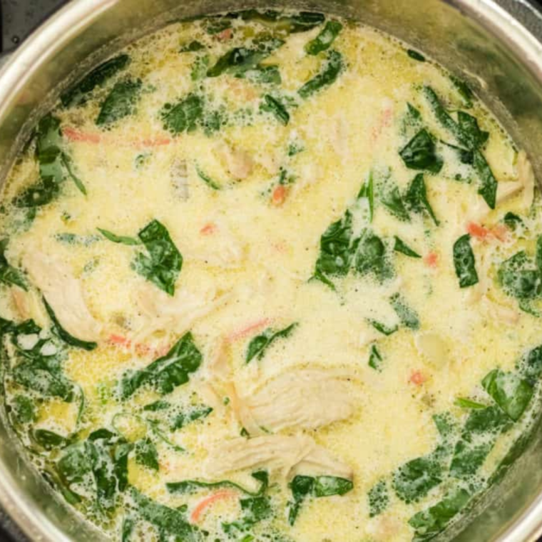 "Close-up of a ladle scooping out a serving of Chicken Gnocchi Soup from the Instant Pot."