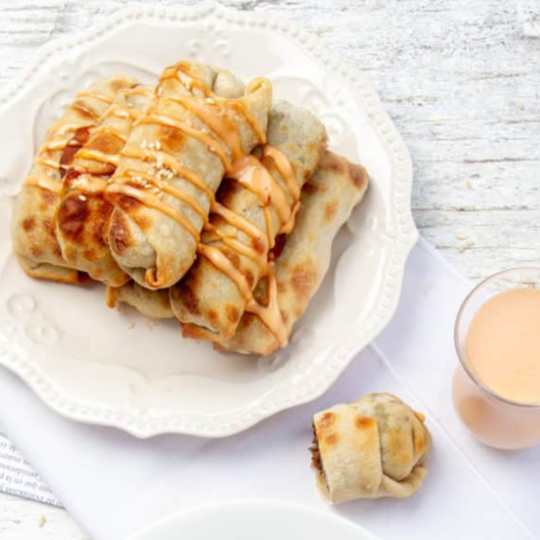 Air Fryer Big Mac Egg Rolls, golden brown and crispy, served with dipping sauce.
