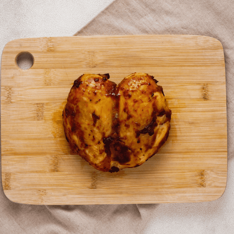 Drizzling barbecue sauce over the completed Air Fryer BBQ Chicken Salad