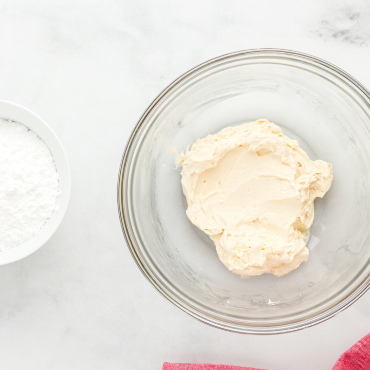 Frosting ingredients measured into bowls on a table