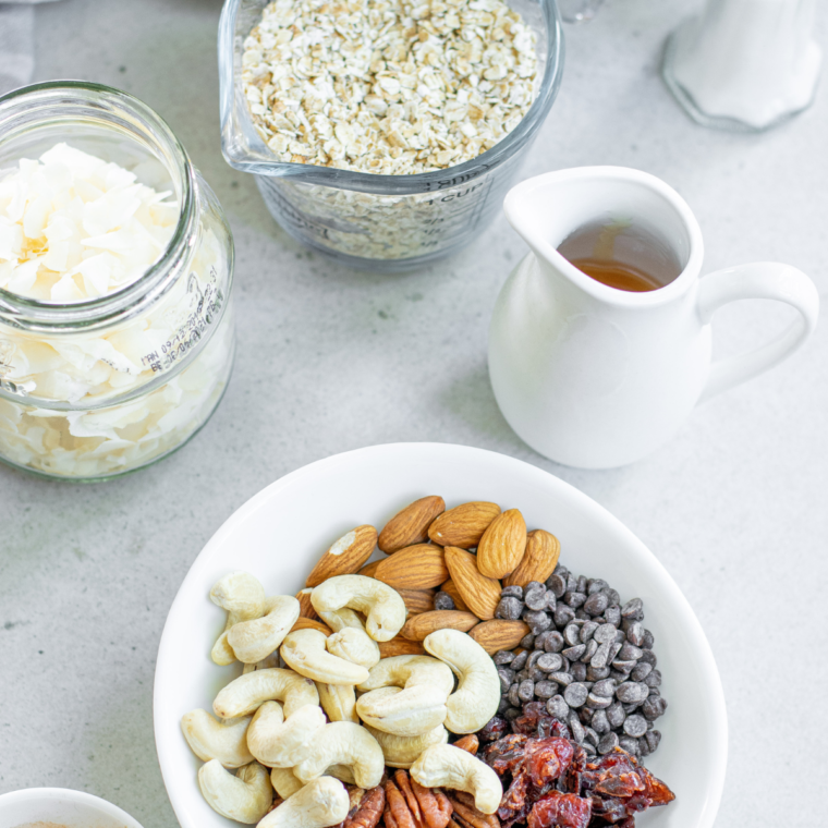 cranberry granola ingredients you will need on a flat white surface, overhead shot