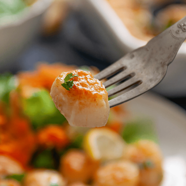 Q: Can I use frozen scallops for this recipe? A: Yes, you can use frozen scallops, but make sure to thaw them completely and pat them dry to remove excess moisture before cooking. Q: How do I know when the scallops are done cooking? A: Scallops are done when they turn opaque and have a slightly firm texture. Overcooking can make them rubbery, so it's important to keep an eye on them. Q: Can I make Parmesan Crusted Scallops without an air fryer? A: Yes, you can bake them in a preheated oven at 400°F (200°C) for about 10-12 minutes or until the crust is golden and the scallops are cooked through. Q: What should I serve with Parmesan Crusted Scallops? A: They pair well with light sides like steamed vegetables, a fresh salad, or over a bed of pasta with a light sauce. Q: How long can I store cooked scallops in the refrigerator? A: Cooked scallops can be stored in the refrigerator for up to two days in an airtight container. Q: Can I use a different type of cheese for the crust? A: Parmesan is preferred for its flavor and ability to crisp up, but you can experiment with other hard, aged cheeses like Asiago or Pecorino Romano. Q: Is it necessary to remove the side muscle from scallops? A: Yes, the side muscle can be tough and chewy. It's best to remove it for a better texture. Q: Can Parmesan Crusted Scallops be reheated? A: While they're best enjoyed fresh, you can reheat them gently in the oven or air fryer. However, be mindful that reheating may alter their texture. Q: Are Parmesan Crusted Scallops gluten-free? A: They can be made gluten-free by using gluten-free breadcrumbs or a suitable alternative for the crust. Q: How can I ensure a crispy crust on the scallops? A: Make sure the scallops are dry before coating them, and don't overcrowd them in the air fryer. Also, preheating the air fryer can help achieve a crispier crust.