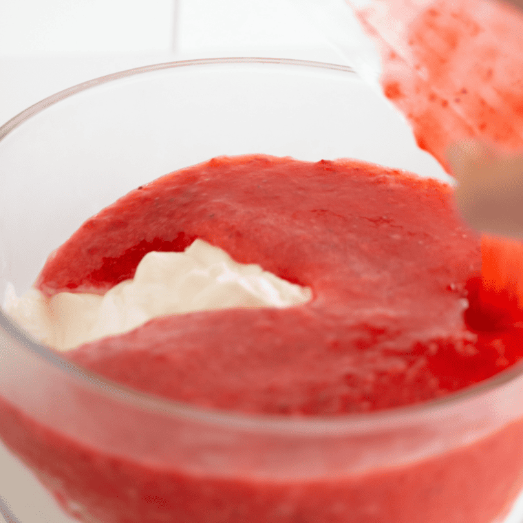 Beating cream cheese with sugar, vanilla, and egg until smooth and creamy for cheesecake filling.