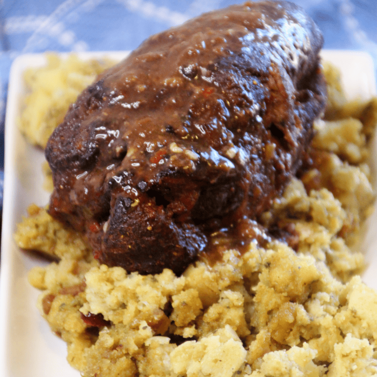 Tender, slow-cooked Trader Joe’s pork shoulder served with vegetables and herbs, showcasing its juicy, flavorful texture.