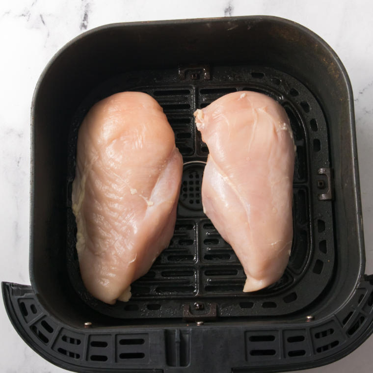 Cooked chicken breast ready to shred for copycat Zoe's chicken salad