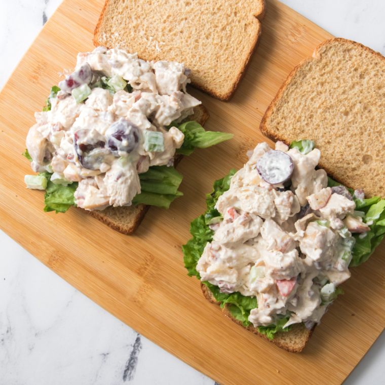 Stirring mayonnaise and celery into shredded chicken to make chicken salad