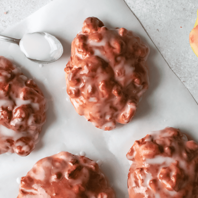 Apple fritters air frying until golden in the air fryer basket