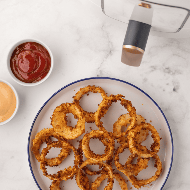 Crispy golden Air Fryer Beer Battered Onion Rings served on a plate.