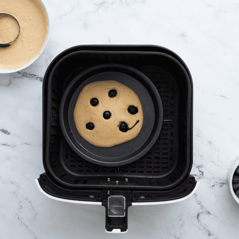 Air fryer blueberry pancake sliced and served with butter and syrup