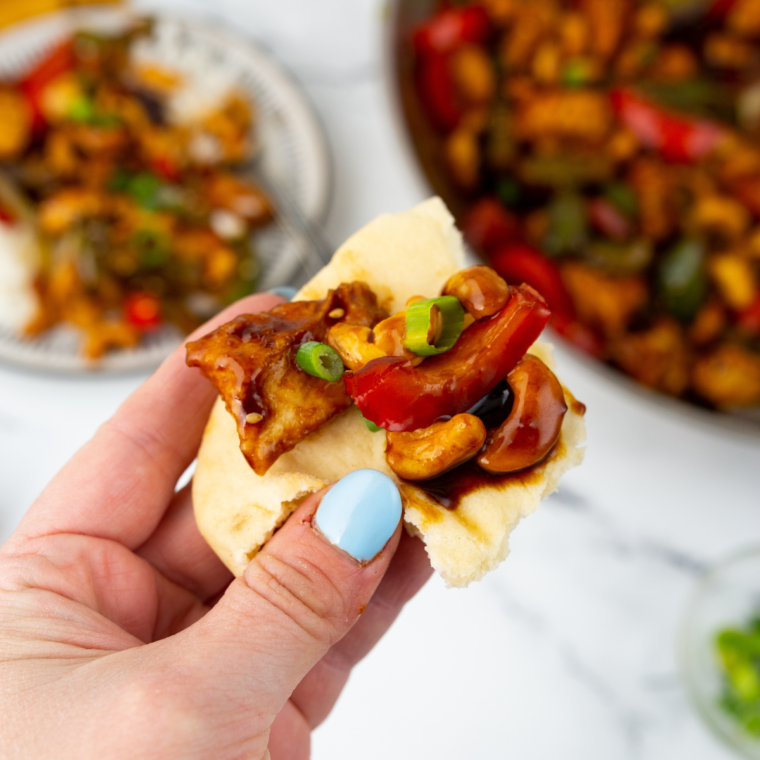 Serving of Air Fryer Cashew Chicken on a plate with golden chicken and crunchy cashews."