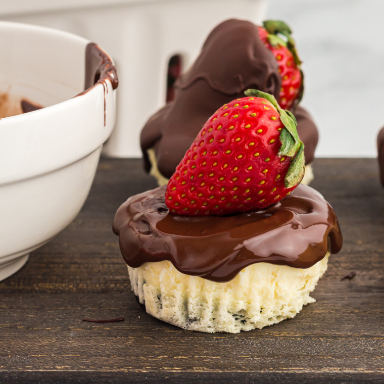 Chocolate strawberry mini cheesecakes arranged on a serving board