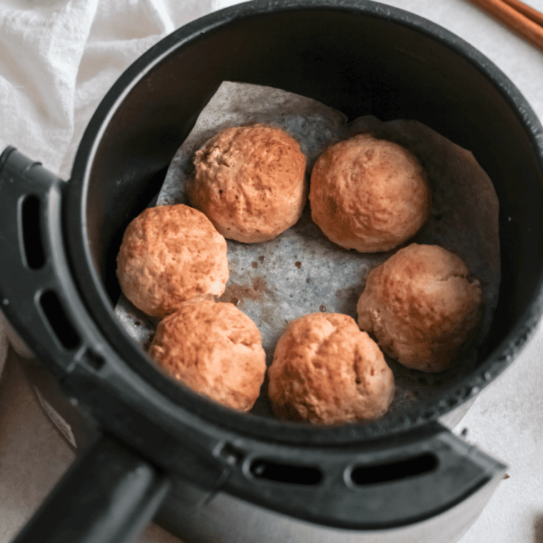 Cook the Air Fryer Cinnamon Sugar Donut Holes until they’re golden brown.