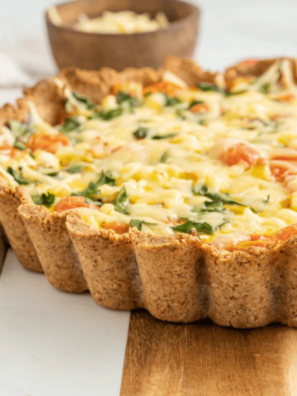 Whole gluten-free quiche in a fluted tart pan on a table