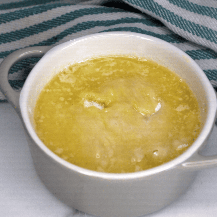 Drizzling melted butter over cake mix before baking air fryer lemon dump cake, no stirring needed.